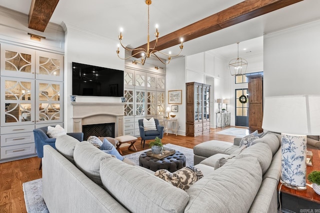 living room featuring crown molding, beamed ceiling, wood-type flooring, and a high ceiling