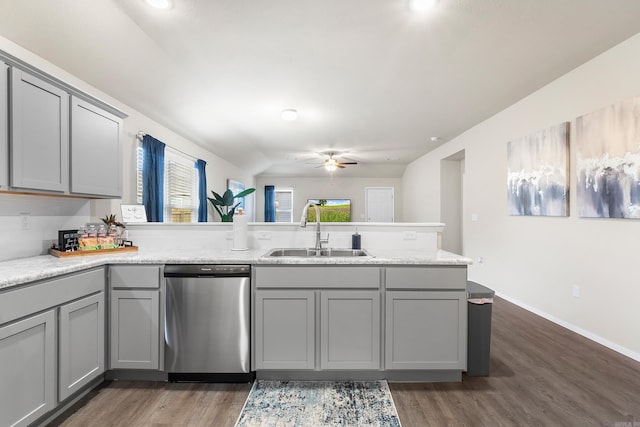 kitchen with dishwasher, dark wood-type flooring, sink, gray cabinets, and kitchen peninsula