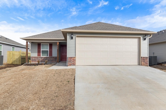 view of front of house featuring a garage and central AC