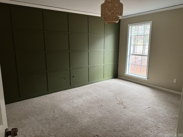 unfurnished room with light colored carpet and crown molding