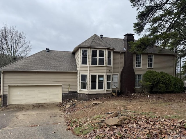 back of property featuring a garage