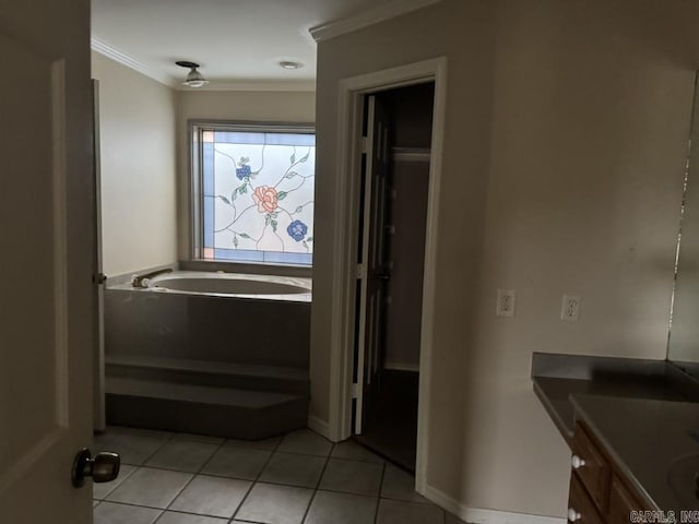 bathroom featuring a bathing tub, tile patterned flooring, ornamental molding, and vanity