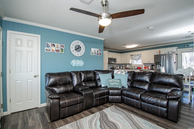 living room featuring crown molding, ceiling fan, and dark hardwood / wood-style floors