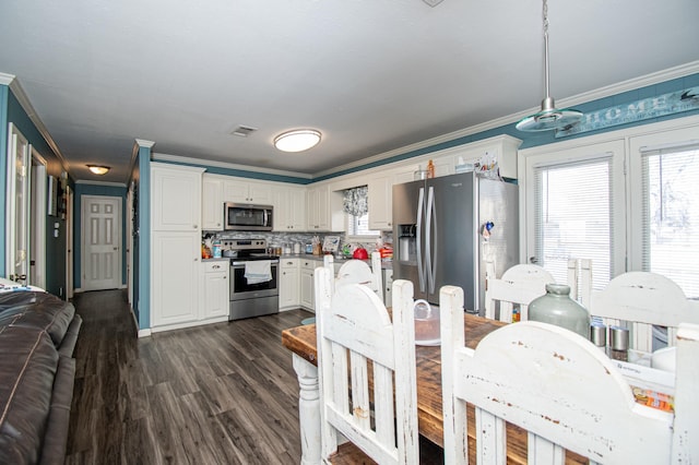 dining area with crown molding and dark wood-type flooring