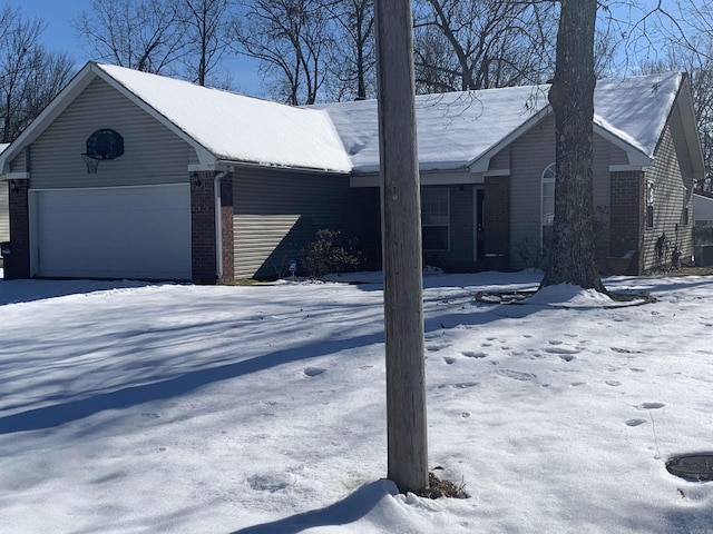 view of snowy exterior with a garage