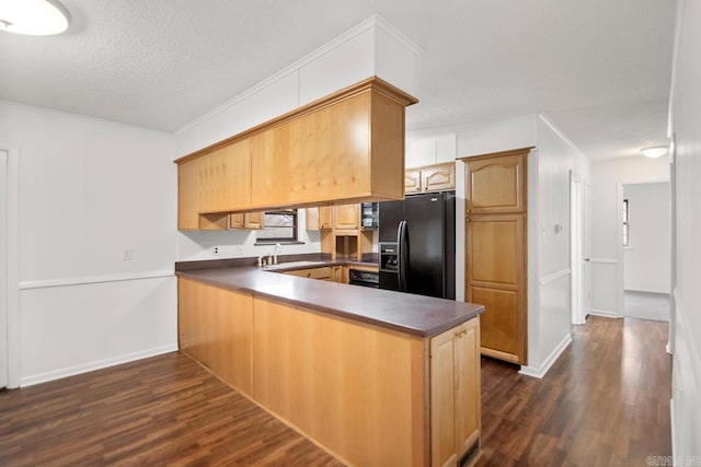 kitchen with sink, dark hardwood / wood-style floors, a textured ceiling, black fridge with ice dispenser, and kitchen peninsula