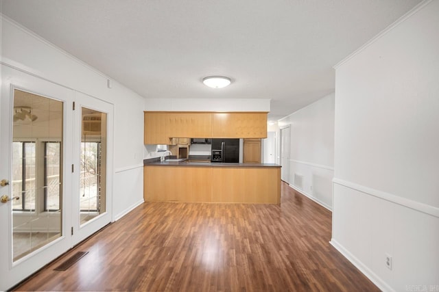 kitchen with kitchen peninsula, ornamental molding, black fridge with ice dispenser, dark hardwood / wood-style floors, and range hood