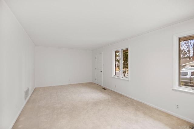 carpeted empty room featuring plenty of natural light