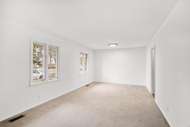 carpeted spare room with ornamental molding