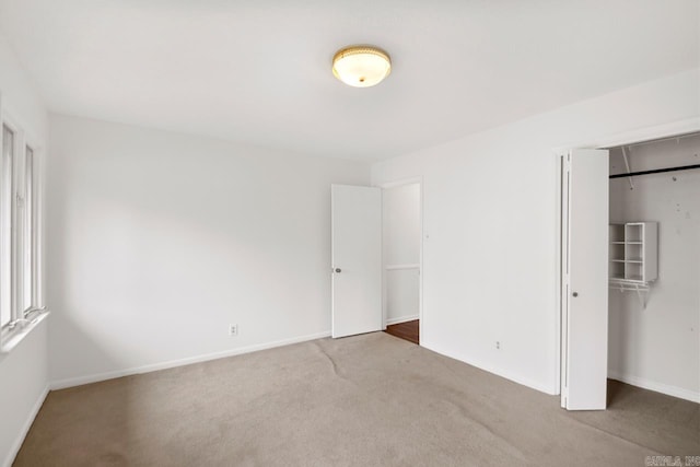 unfurnished bedroom with carpet flooring and a closet