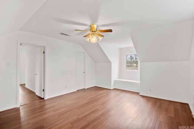 bonus room featuring hardwood / wood-style floors, vaulted ceiling, and ceiling fan