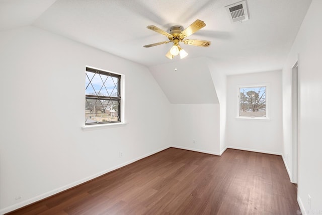 bonus room with ceiling fan, dark hardwood / wood-style flooring, and lofted ceiling