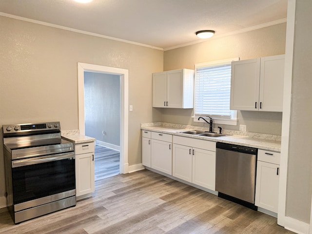 kitchen with sink, white cabinetry, light hardwood / wood-style flooring, ornamental molding, and stainless steel appliances