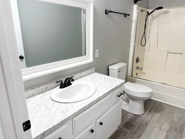 full bathroom featuring shower / bathing tub combination, vanity, hardwood / wood-style floors, and toilet