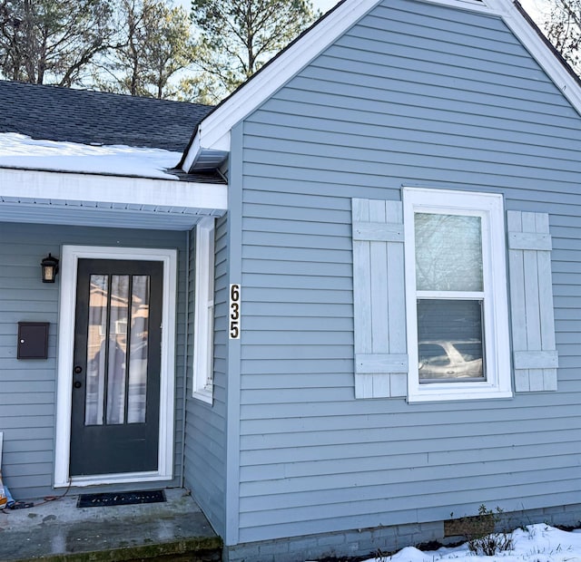 view of snow covered property entrance