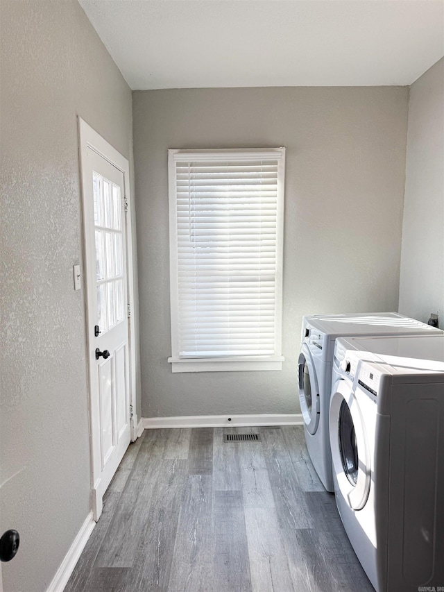 laundry area with washer and clothes dryer and dark hardwood / wood-style floors