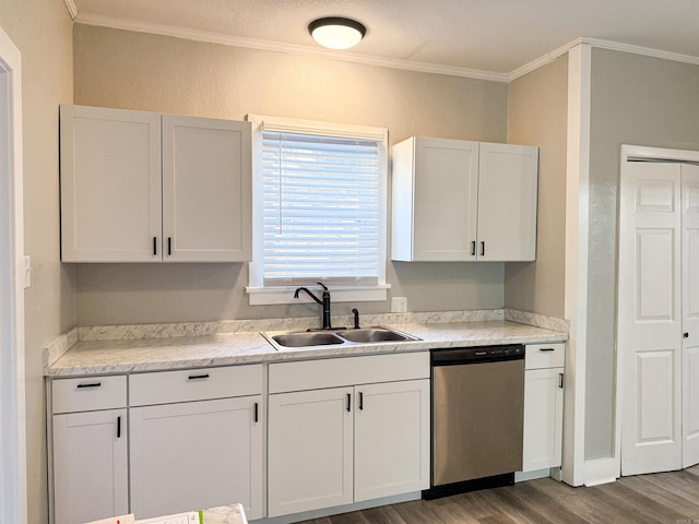 kitchen with sink, hardwood / wood-style flooring, ornamental molding, white cabinets, and stainless steel dishwasher