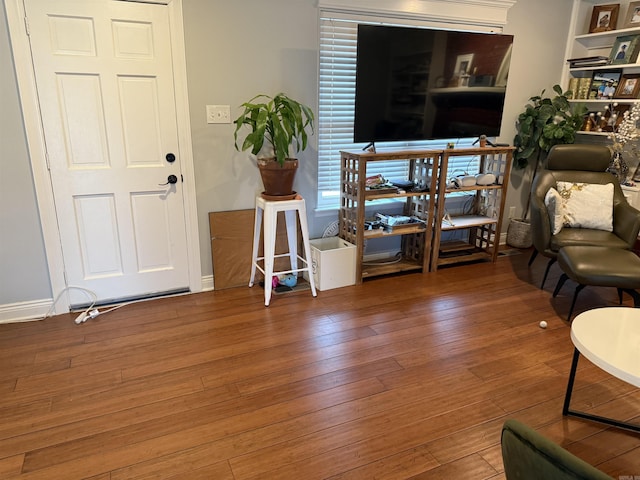 living room featuring built in features and hardwood / wood-style flooring