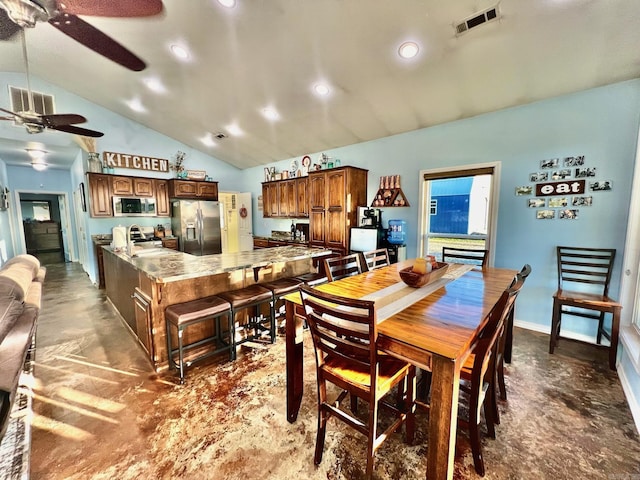 dining room with ceiling fan, sink, and vaulted ceiling