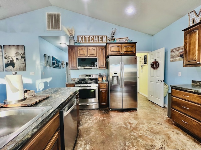 kitchen featuring stainless steel appliances, vaulted ceiling, and sink