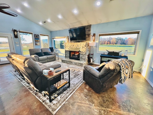 living room featuring concrete flooring, a fireplace, and vaulted ceiling