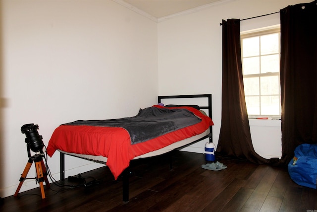 bedroom with hardwood / wood-style flooring, multiple windows, and ornamental molding