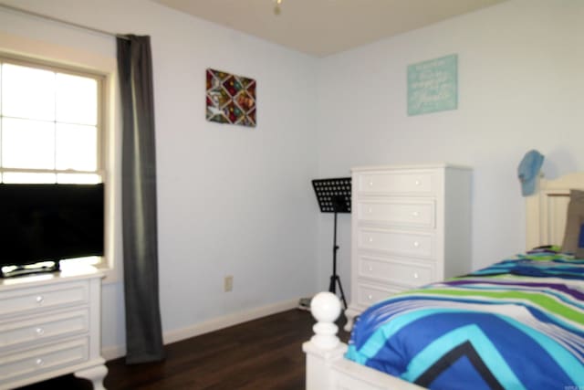 bedroom with dark hardwood / wood-style flooring