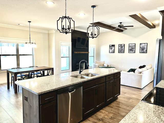 kitchen featuring beamed ceiling, sink, stainless steel appliances, and hanging light fixtures