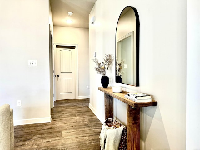 hallway with hardwood / wood-style floors