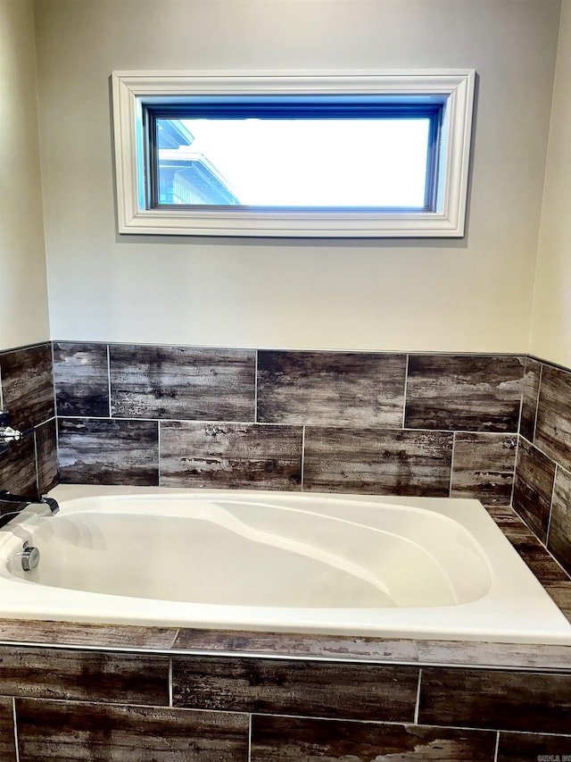 bathroom featuring tiled bath