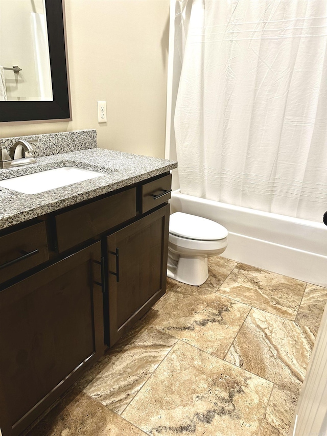 full bathroom featuring shower / tub combo, vanity, and toilet