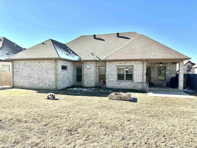 rear view of property with a yard and a patio area