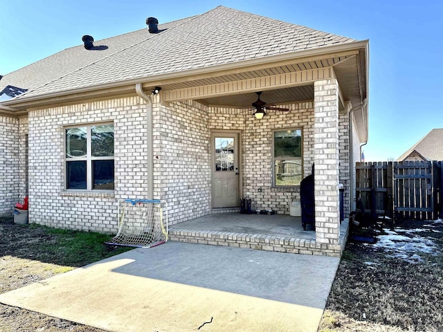 view of exterior entry with a patio area and ceiling fan