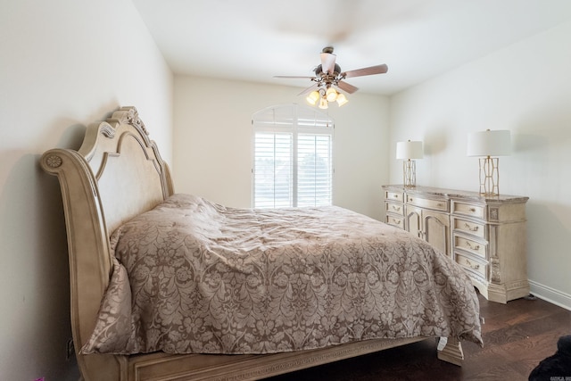 bedroom with ceiling fan and dark hardwood / wood-style floors