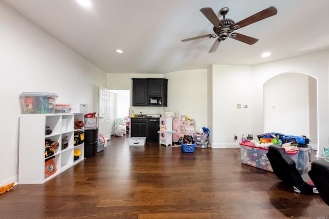 playroom featuring ceiling fan and dark wood-type flooring