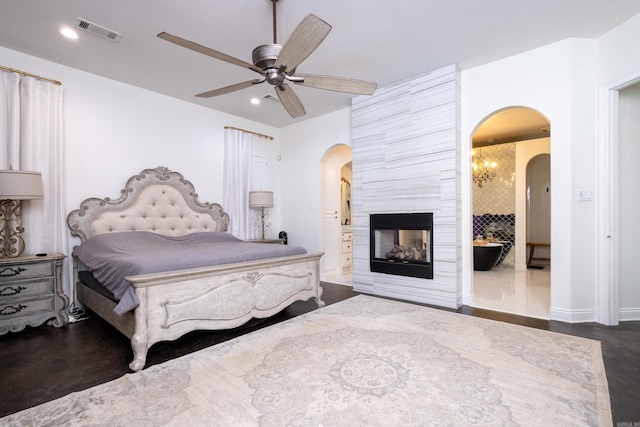 bedroom featuring ceiling fan and a fireplace