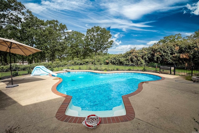 view of pool with a patio area and a water slide