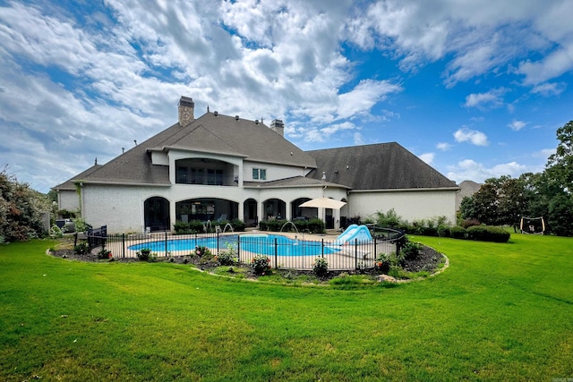 back of house featuring a lawn, a patio area, and a balcony