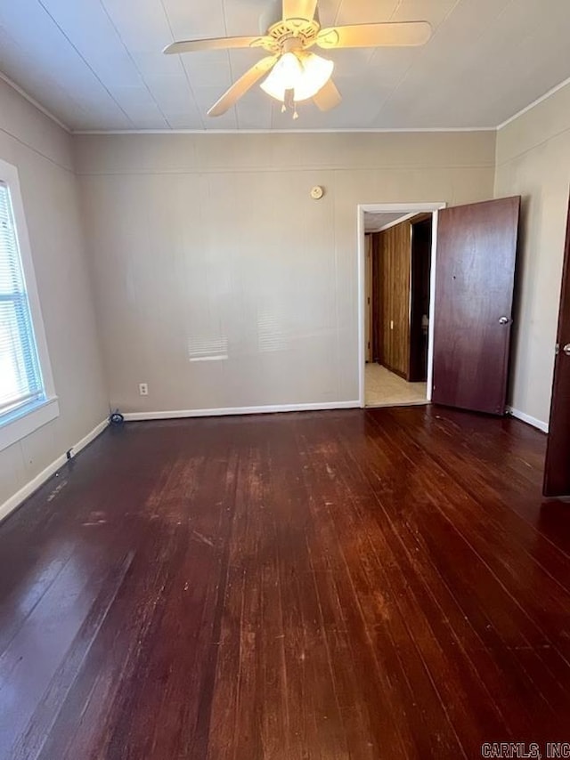 empty room featuring ceiling fan and dark hardwood / wood-style flooring