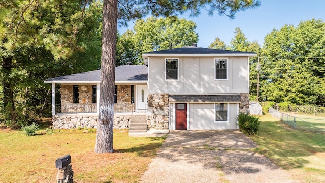 split level home with a front yard and a porch