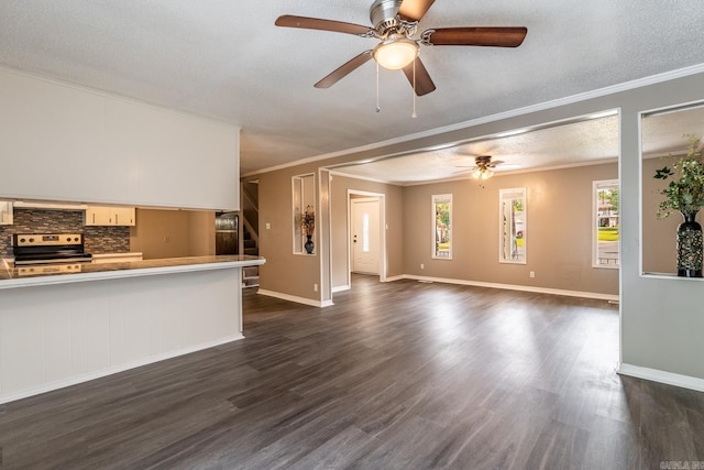 unfurnished living room featuring dark hardwood / wood-style flooring, a textured ceiling, and ornamental molding