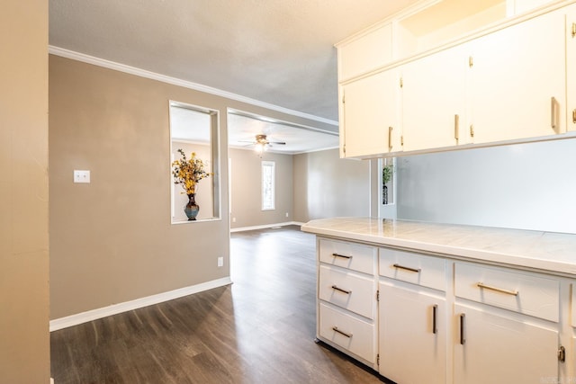 kitchen with dark hardwood / wood-style floors, white cabinetry, tile counters, and ceiling fan