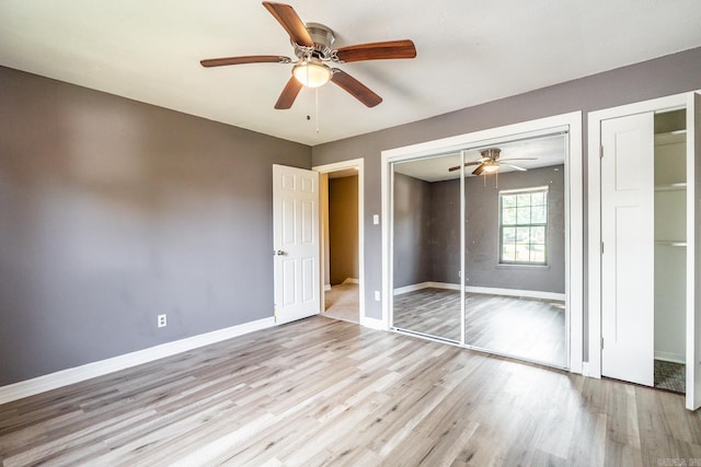 unfurnished bedroom featuring light wood-type flooring and ceiling fan