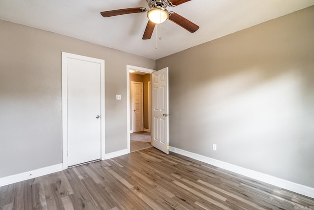 unfurnished bedroom with ceiling fan and light hardwood / wood-style floors