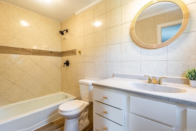 full bathroom with a textured ceiling, vanity, shower / washtub combination, tile walls, and toilet