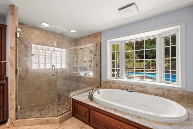 bathroom featuring tile patterned floors and separate shower and tub