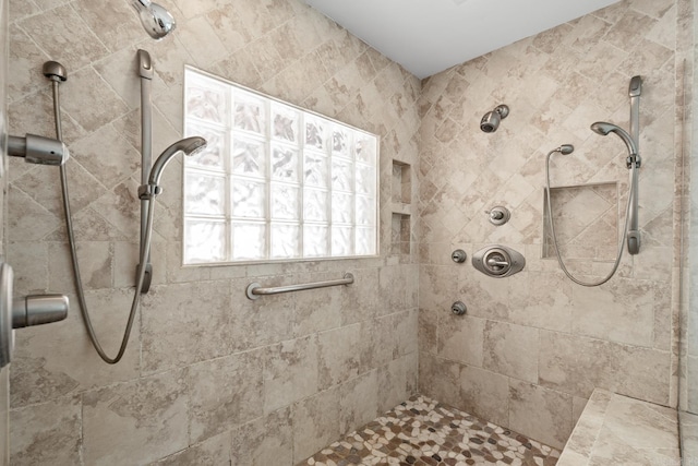 bathroom with a tile shower