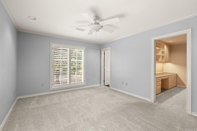 carpeted empty room with crown molding and ceiling fan