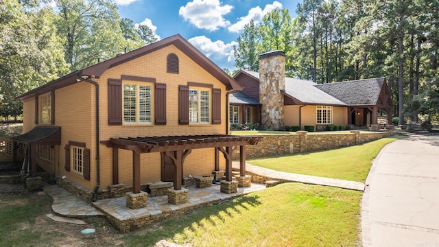 view of front of property with a pergola, a patio, and a front lawn