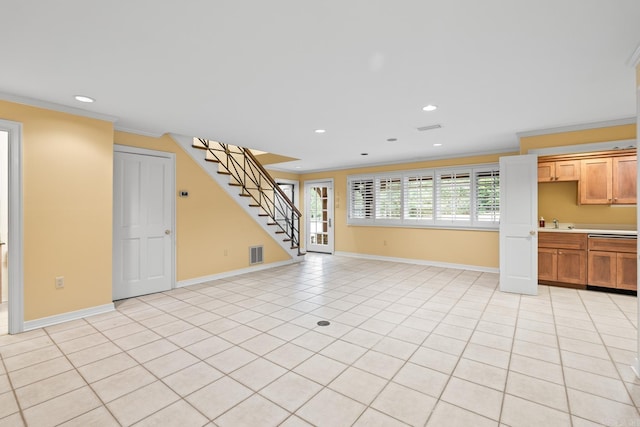 unfurnished living room featuring crown molding, sink, and light tile patterned flooring